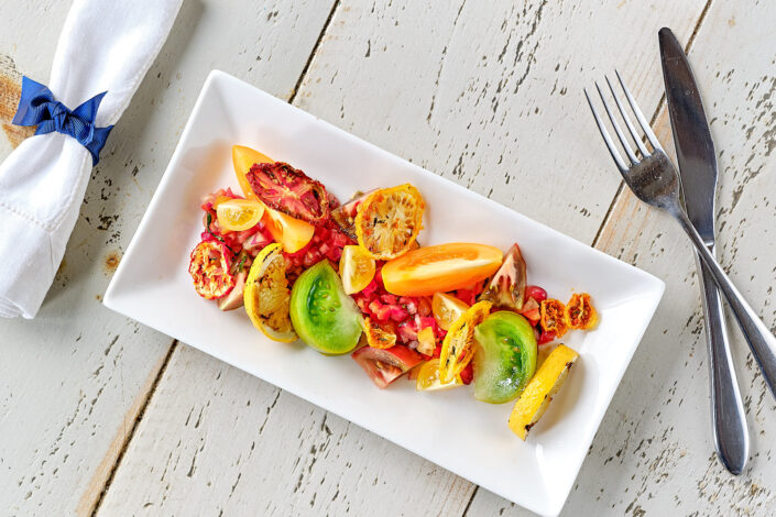 A colourful plate of tomatoes served as a summer salad.