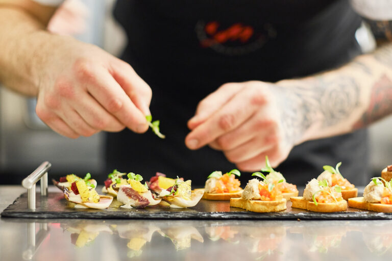 A chef adds the final touches to a dish.